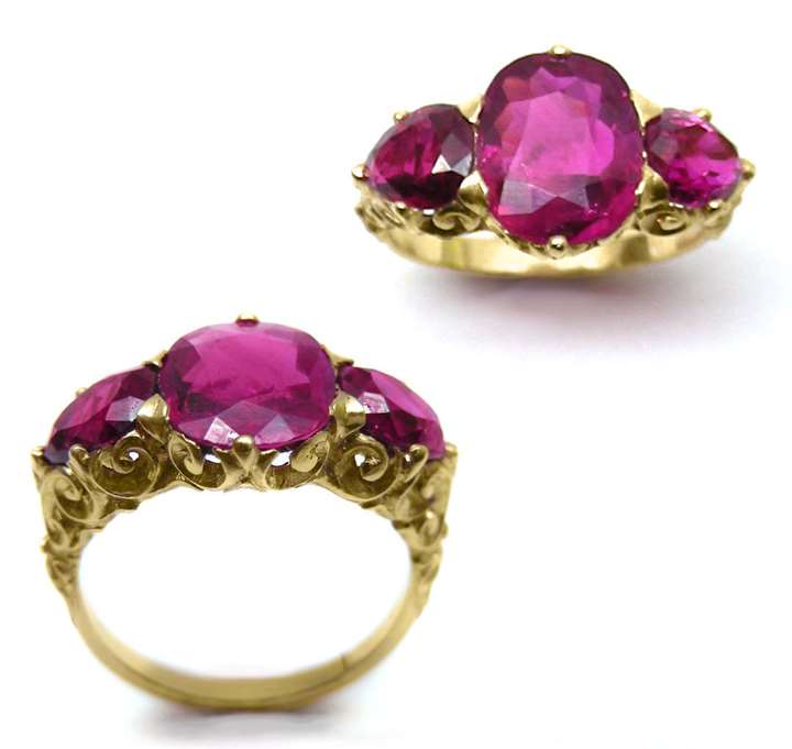 Three stone Burma ruby ring, the central oval cushion-cut ruby